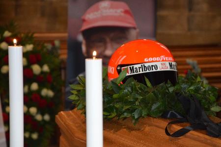 Niki Lauda wird im Rennoverall und mit Rennhelm auf dem Sarg aufgebahrt
