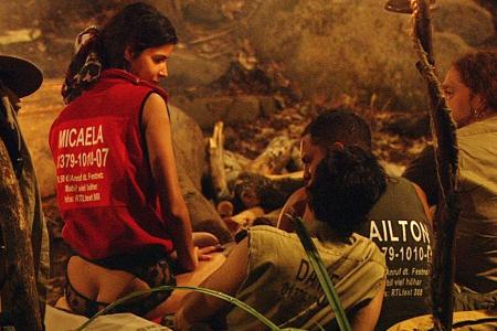 Erotik-Model Micaela Schäfer läuft - wie immer - sehr knapp bekleidet im Camp rum und setzt sich provokant auf Daniels Schoß.