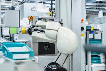 Arm of assembly robot functioning inside modern factory, Stu...