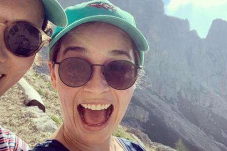 Emilia Clarke strahlt auf dem Berggipfel