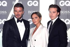 David Beckham (l.) mit seiner Frau Victoria und Sohn Brooklyn bei den "GQ Men Of The Year Awards"