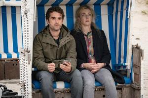 "Nord Nord Mord: Sievers und die Tote im Strandkorb": Hinnerk (Oliver Wnuk) setzt sich direkt neben die Leiche von Marion Ca...