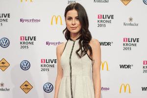 Sängerin Lena kombiniert zum schlichten Minikleid schwarze Overknees