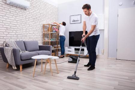 Two Young Janitors Cleaning The Living Room ,model released,...