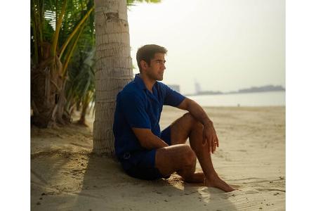 Mann präsentiert Modekollektion von Lamborghini und Orlebar Brown.