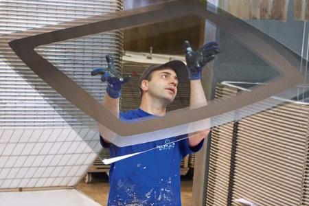 Die Scheibe eines vorgehängten Fensters wird in eine Form gebracht und der Rand bedruckt