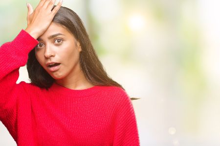 frau fasst sich vergesslich an den kopf