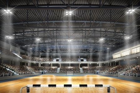 Große Halle mit Handballfeld und leeren Tribünen