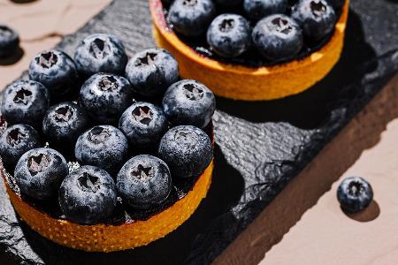 Süßes Gebäck im Mini-Format: Heidelbeer-Tartelettes mit Vanillecreme
