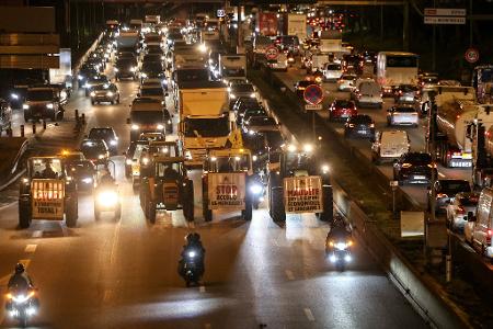 Traktoren sind auf der Pariser Ringstraße unterwegs.