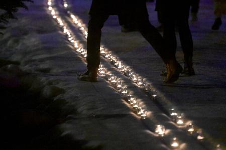 Kerzen in einer symbolischen Loipe erinnern an Laura Dahlmeier. 