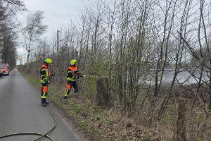 Einsatzkräfte löschen den Brand an den Gleisen