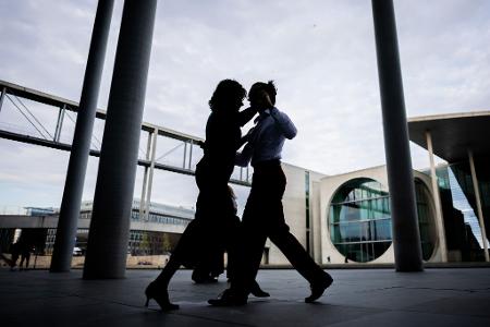 Ein Mann und eine Frau tanzen im Regierungsviertel in Berlin am Paul-Löbe-Haus des Deutschen Bundestages Tango.