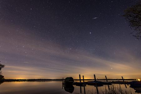 Eine Sternschnuppe der Lyriden ist am Nachthimmel über dem Spremberger Stausee in Brandenburg zu sehen.