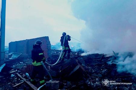 Auf diesem vom ukrainischen Katastrophenschutz zur Verfügung gestellten Foto löschen Rettungskräfte ein Feuer in einem Wohnhaus in Dnipro, das bei einem Angriff zerstört wurde.