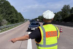 Ein Kontrollbeamter lotst die Fahrzeuge auf den Rastplatz
Foto: Polizei (freigegeben)