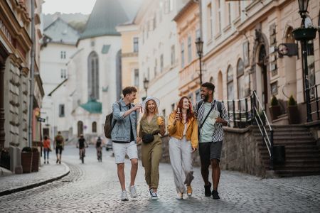 Vier junge Leute laufen durch eine Stadt