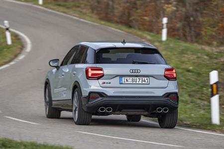 Audi SQ2 TSFI quattro S-tronic fährt auf einer kurvigen Landstraße, fotografiert von hinten.