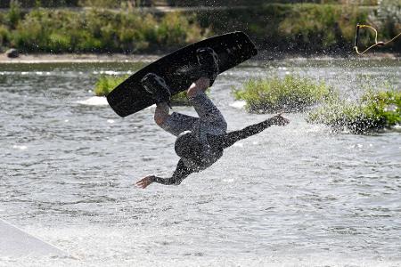 Mit Tempo übers Wasser: Mann auf Wakeboard-Anlage unterwegs
