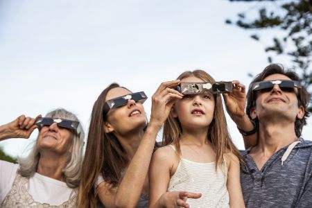 Menschen mit speziellen Brillen schauen in den Himmel