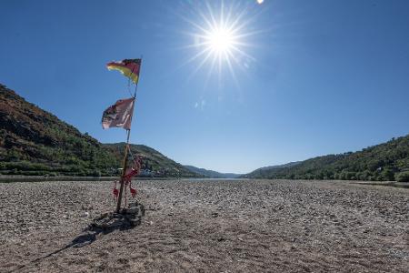 Dürre am Mittelrhein: Ein improvisierter Fahnenmast mit zwei drei rosa Flamingos steht im ausgetrockneten Rheinbett bei Bacharach