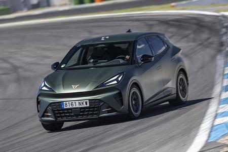 Der Cupra Raval fährt auf einer Rennstrecke, vermutlich Hockenheim, in einer dynamischen Kurvenfahrt.