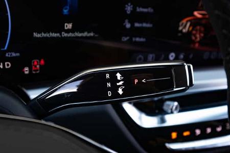 Detailaufnahme des Automatikwählhebels im Cadillac Lyriq-V. Das Foto zeigt den elektronischen Wählhebel mit beleuchteten Schaltpositionen (P, R, N, D) im Innenraum des Fahrzeugs. Im Hintergrund ist das digitale Cockpit mit Fahrinformationen und Fahrzeugstatus zu sehen.
