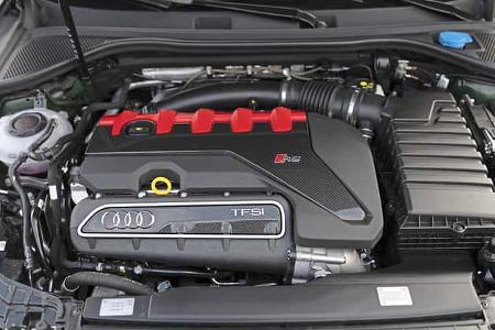 Die Aufnahme zeigt den Motorraum eines Audi RS3 Competition Limited mit dem TFSI‑Fünfzylinder-Triebwerk. Der Motordeckel mit roten Akzenten und RS‑Emblem, die TFSI-Markierung sowie Luftfilterkasten und Ansaugführung sind deutlich erkennbar. Laut IPTC stammt die Aufnahme aus Hockenheim.